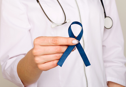 Image of Female Surgeon Holding Blue Ribbon in Honor of Colon Cancer Awareness